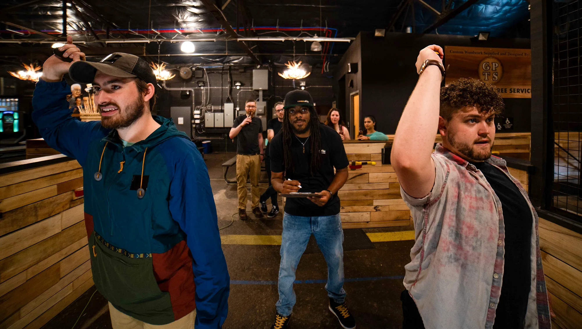 Two guests throwing axes side by side