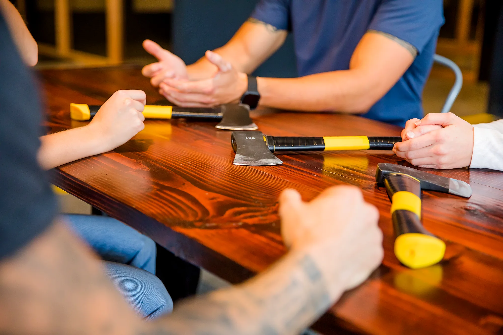 Axes laid out on the table before a throwing session