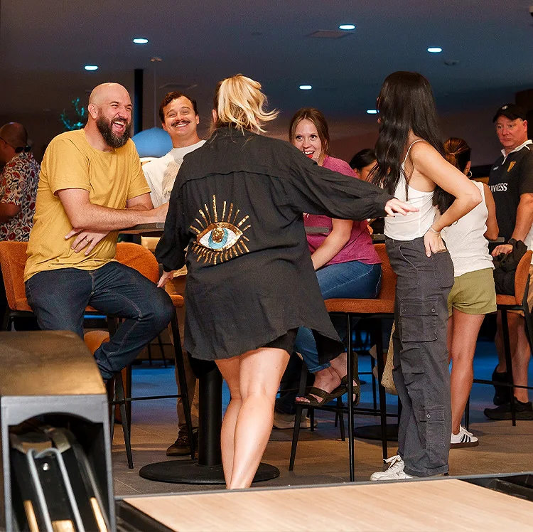 Guests laughing together at the Recess bar